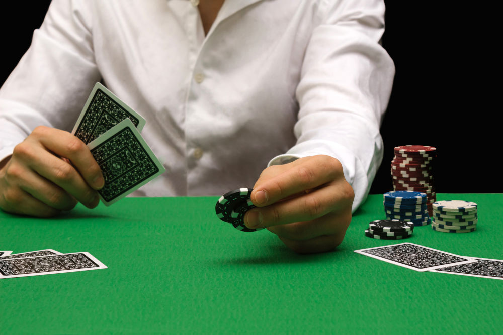 Person in a night casino playing poker, gambling money