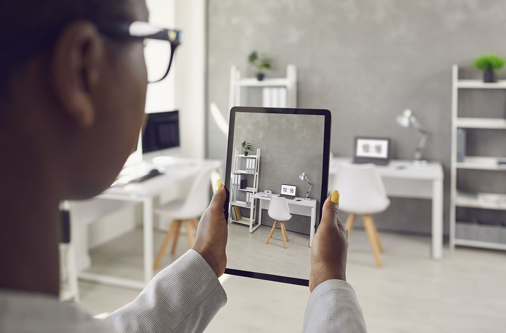 Woman taking photo or video of working space interior in new office or apartment