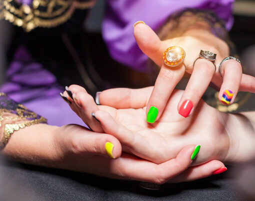 Close up of fortune teller point her finger to womans palm line and read her fortune. Palmistry cpncept