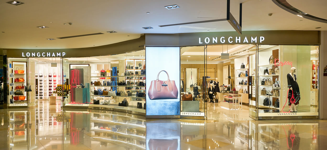Shoppers walk past the French luxury fashion brand Longchamp store