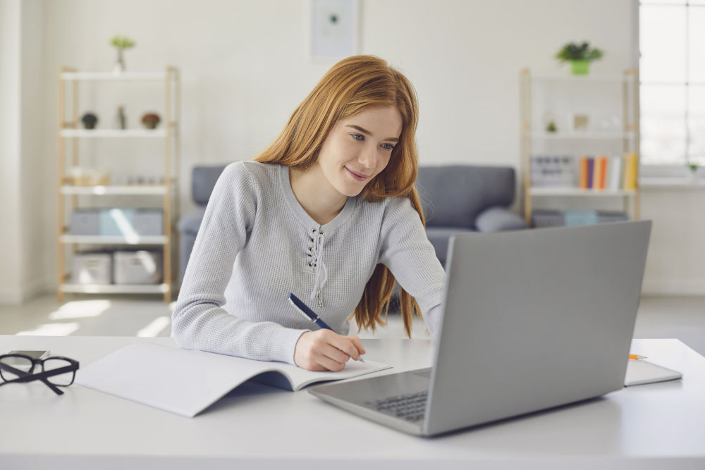 Distance learning.Girl studying a lecture online using a laptop video call at home. Education online course for college university students.