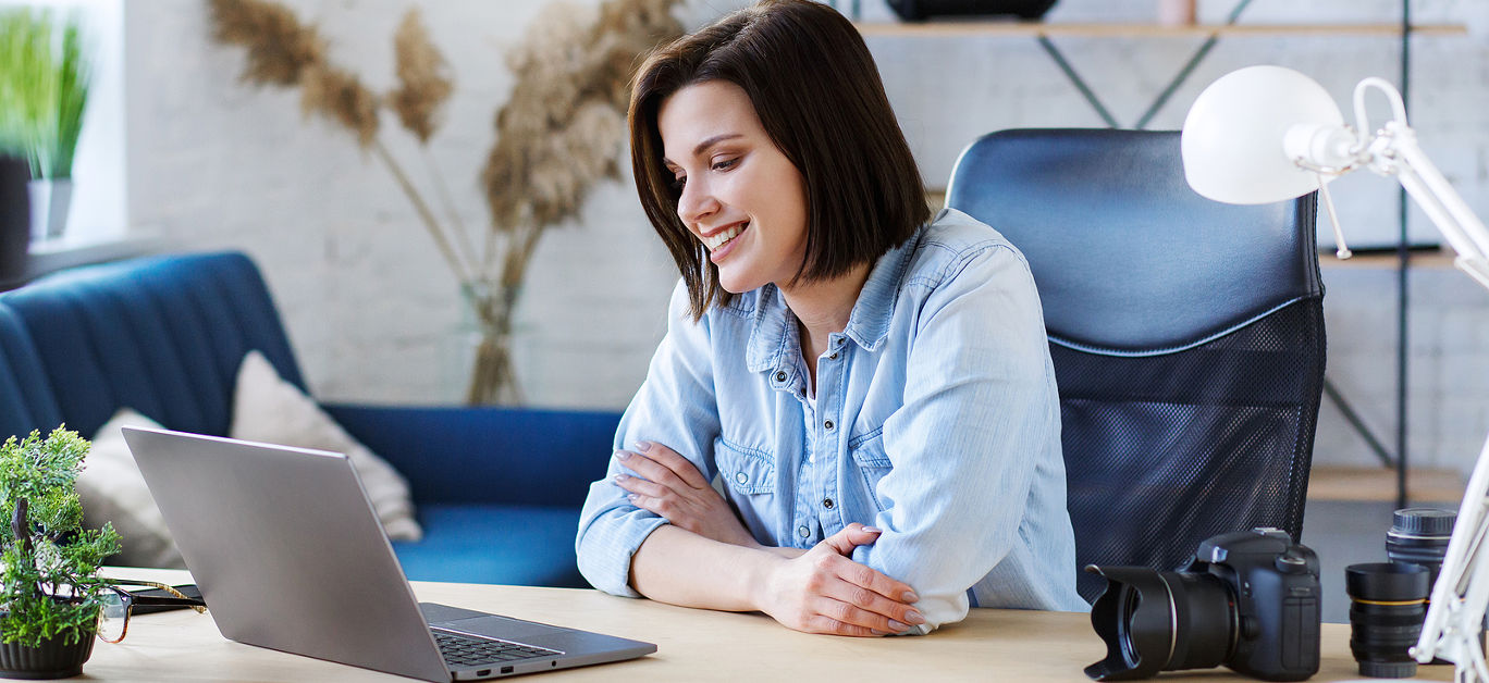 Working from home.Communication online with colleagues and freelancers and video conference. Portrait of smiling female freelancer using laptop for a online meeting in video call.