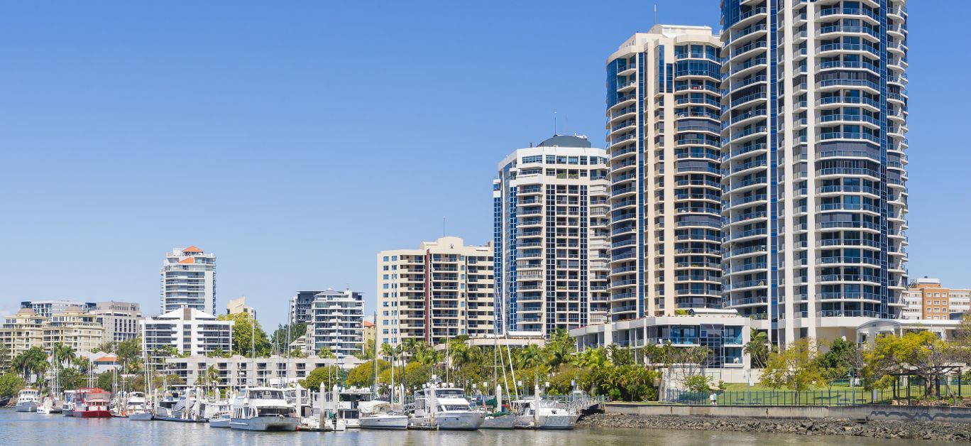 Modern waterfront apartments and yachts in marina in Brisbane during daytime