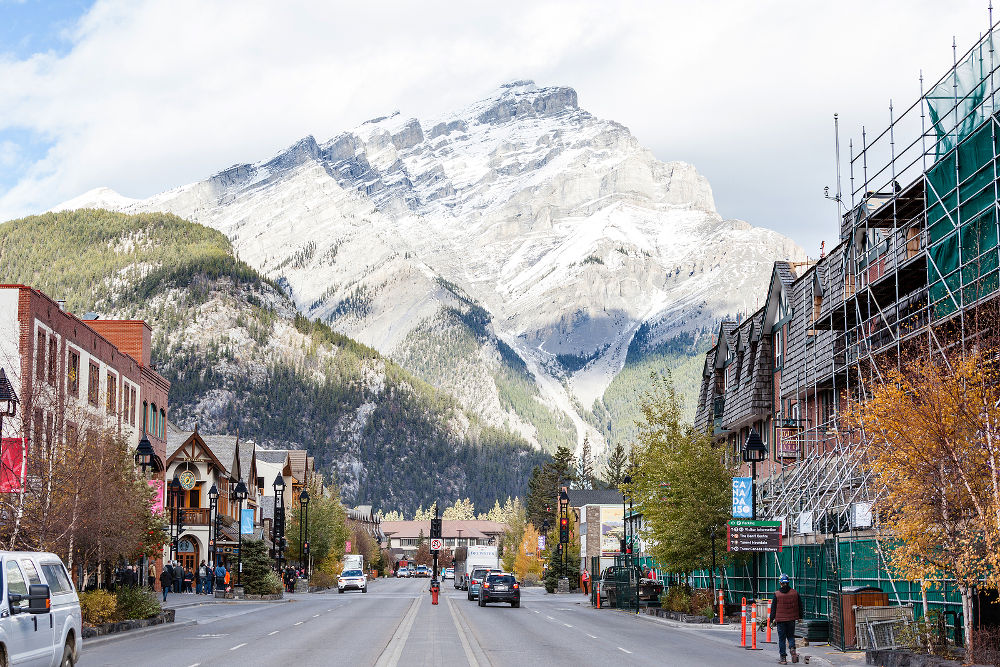 Busy Banff Avenue in the Banff National Park with Cascade Mountain in the background