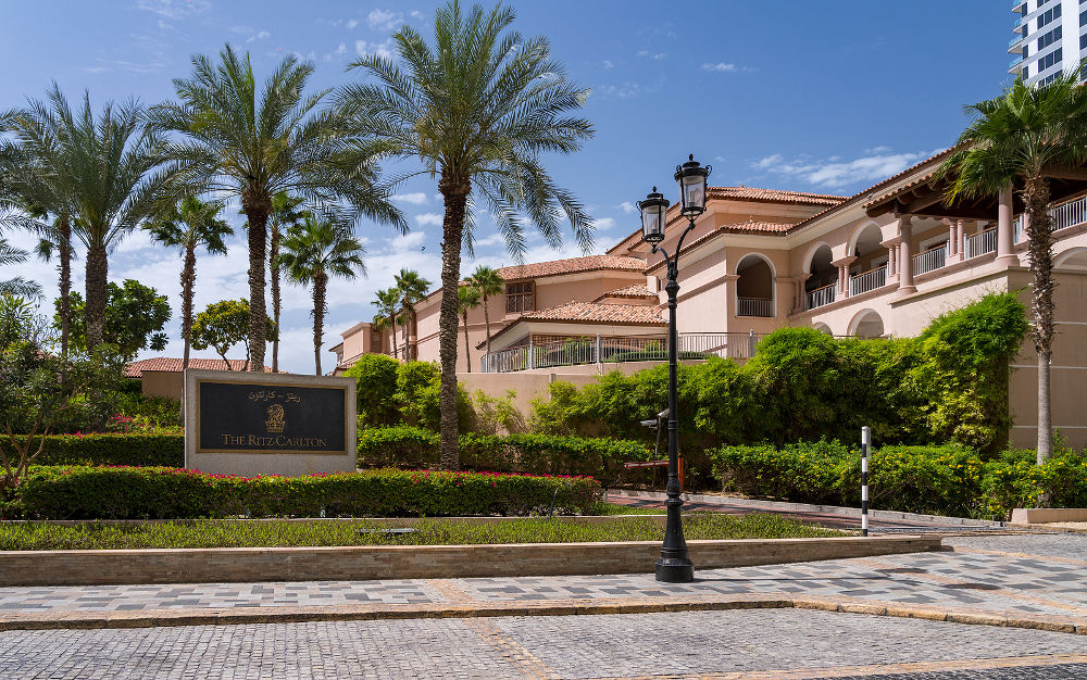 Entrance to Ritz Carlton hotel on Jumeirah Beach Residences road by ocean