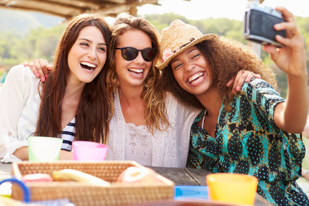 Female Friends Taking Selfie During Lunch Outdoors