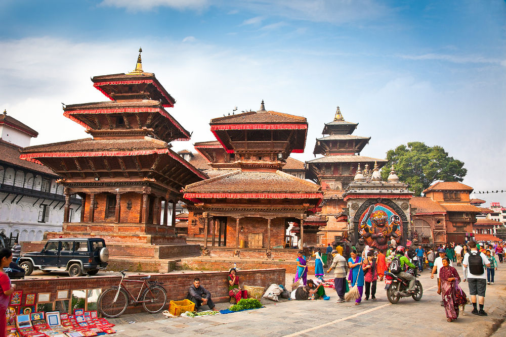 Crowd of local Nepalese people visit the famous Durbar square on May 19, 2013 in Kathmandu, Nepal. Bhaktapur is the third largest city in Kathmandu valley