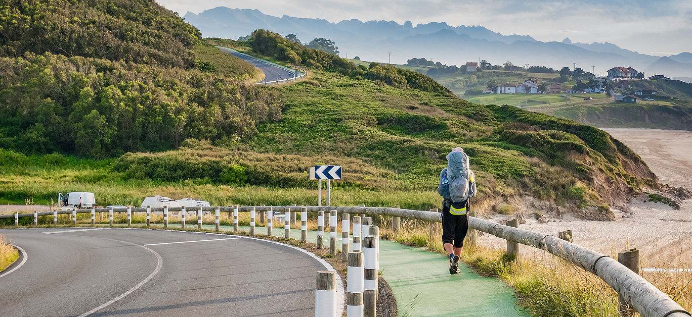 Lonely Pilgrim with backpack walking the Camino de Santiago in Spain, Way of St James