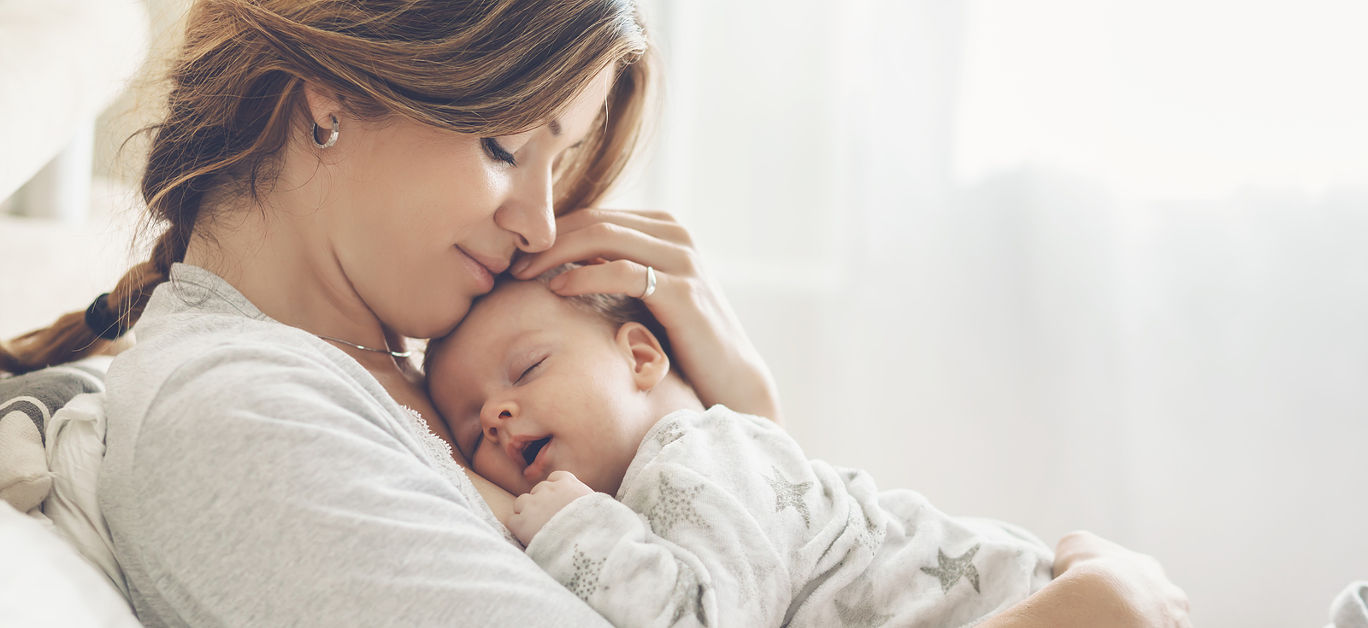 Mother hugging her little 2 months old son