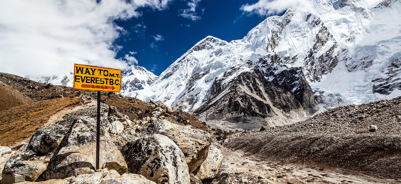 Footpath to Mount Everest Base Camp signpost in Himalayas Nepal. Khumbu glacier and valley snow on mountain peaks beautiful view landscape