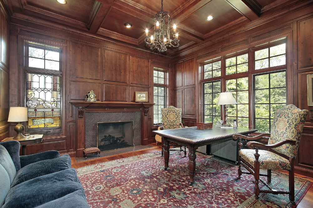 Office with wood paneling and fireplace