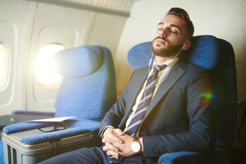 man asleep on flight