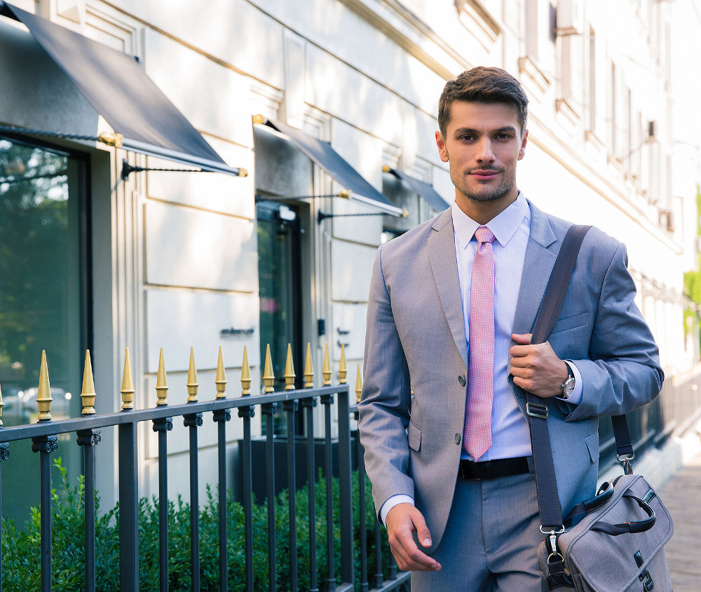 Portrait of a handsome young businessman walking in the city