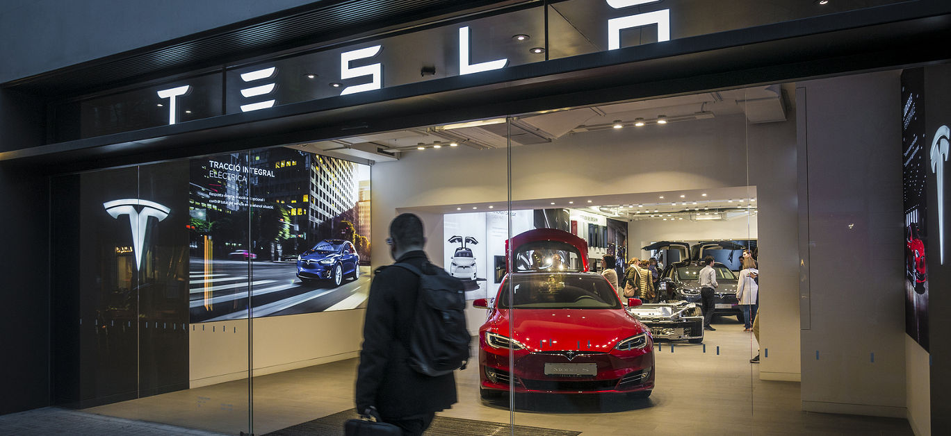 Barcelona, Spain. March 2018: Tesla inc cars flagship store near Passeig de Gracia luxury shopping street with Tesla logo and an electric cars model S and X inside