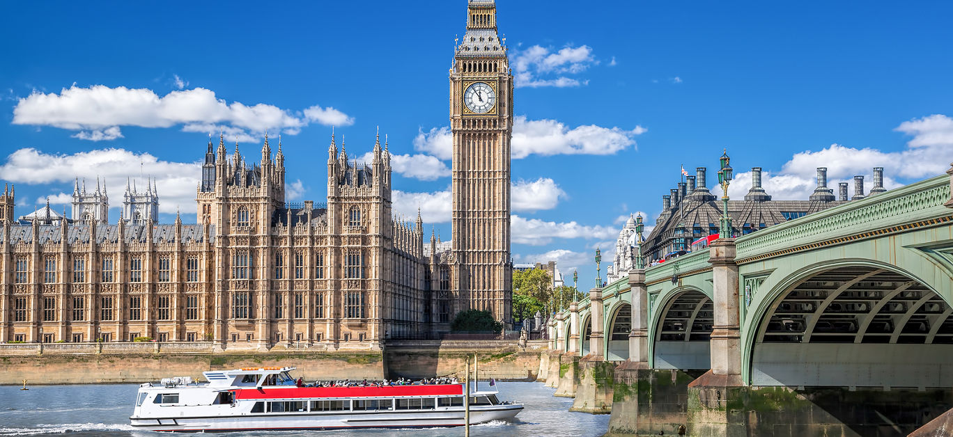 Big Ben and Houses of Parliament with boat in London England UK