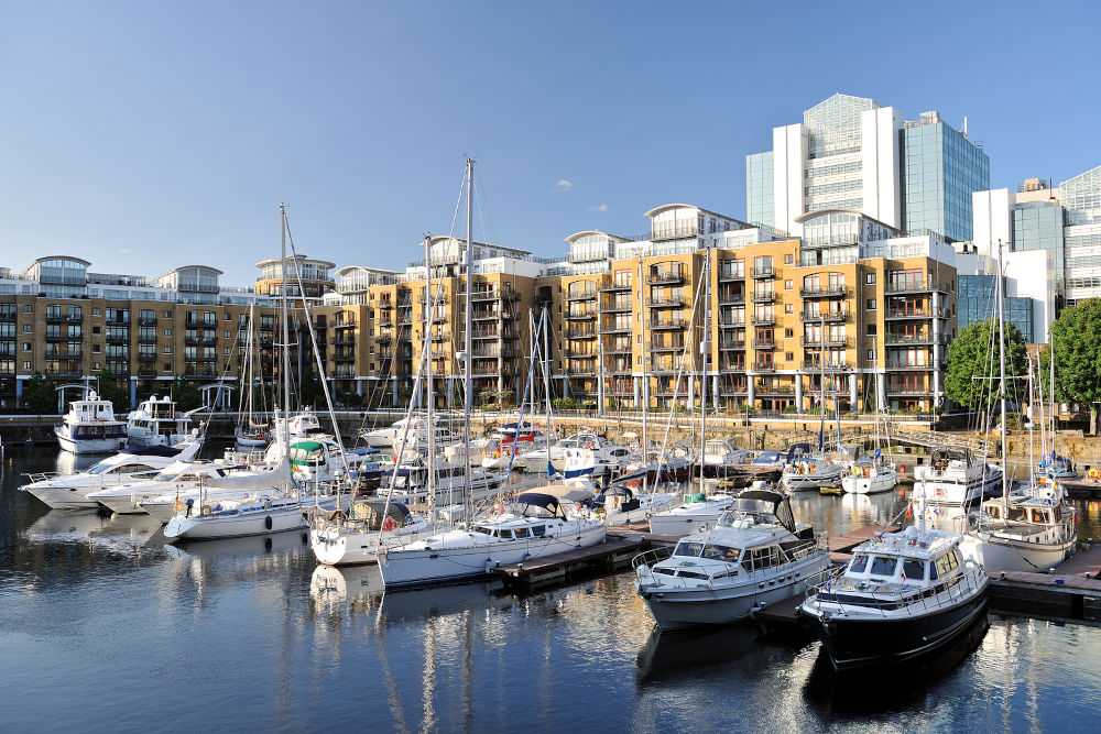 Luxury flats City Quay and yachts moored in the east dock marina St Katherine Dock London England UK Europe