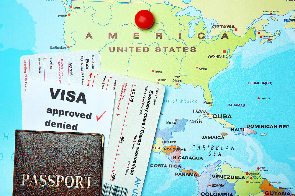Passport, tickets and approved visa on map