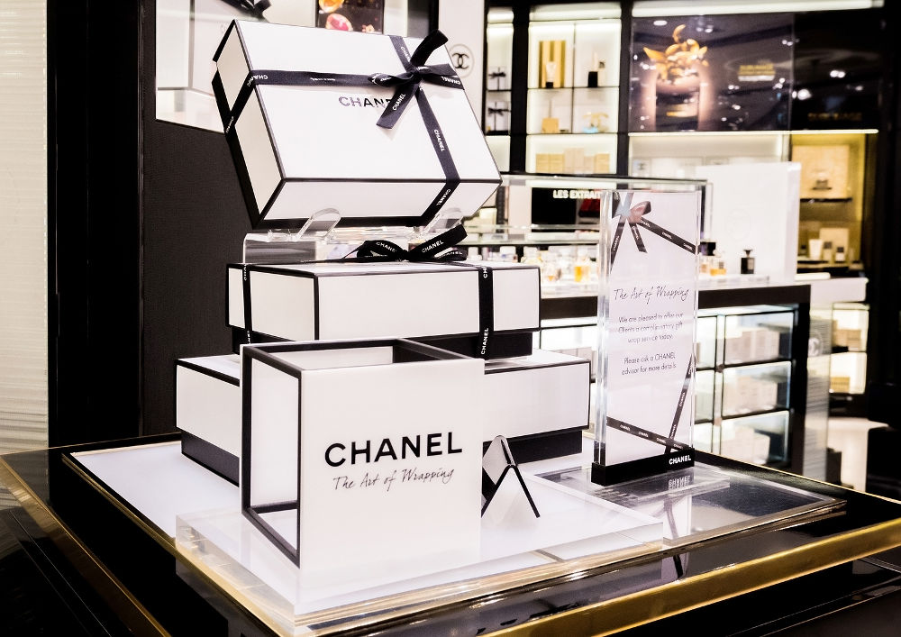 Chanel perfume and cosmetic makeup luxury collection in boutique store. Elegant shop.