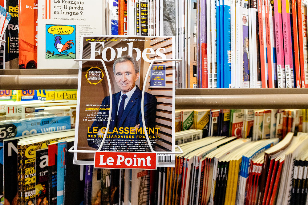 Top of billionaires in France as of Forbes Magazine with portrait of LVMH owner Bernard Arnault at press kiosk