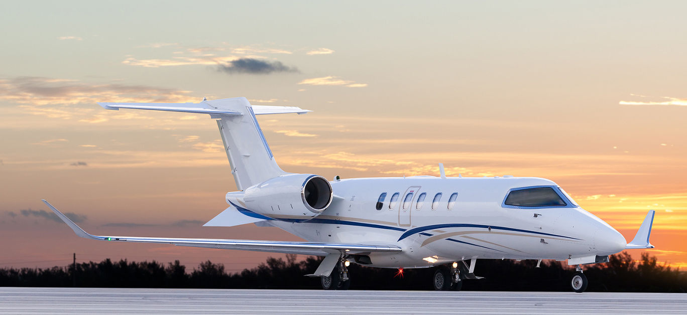 Private jet at the airport with a sunset sky