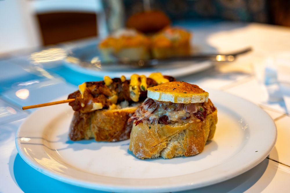 Assortment of typical snacks of Basque Country and Navarre, pinchos or pinxtos, small piece of bread with different toppings, served in bar, Bilbao, Spain, close up