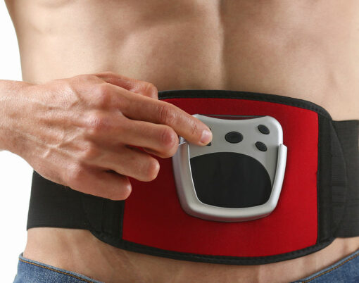 Athletic folded man uses an electric belt simulator for training a press