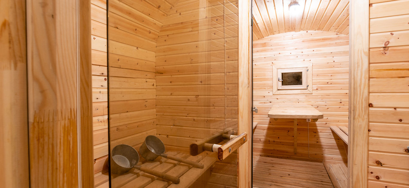 interior. rural mobile wooden sauna in the form of a barrel in a pine forest .