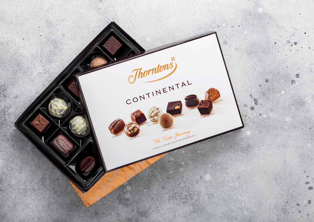 Box of Thorntons Continental Luxury chocolate candies set on white.