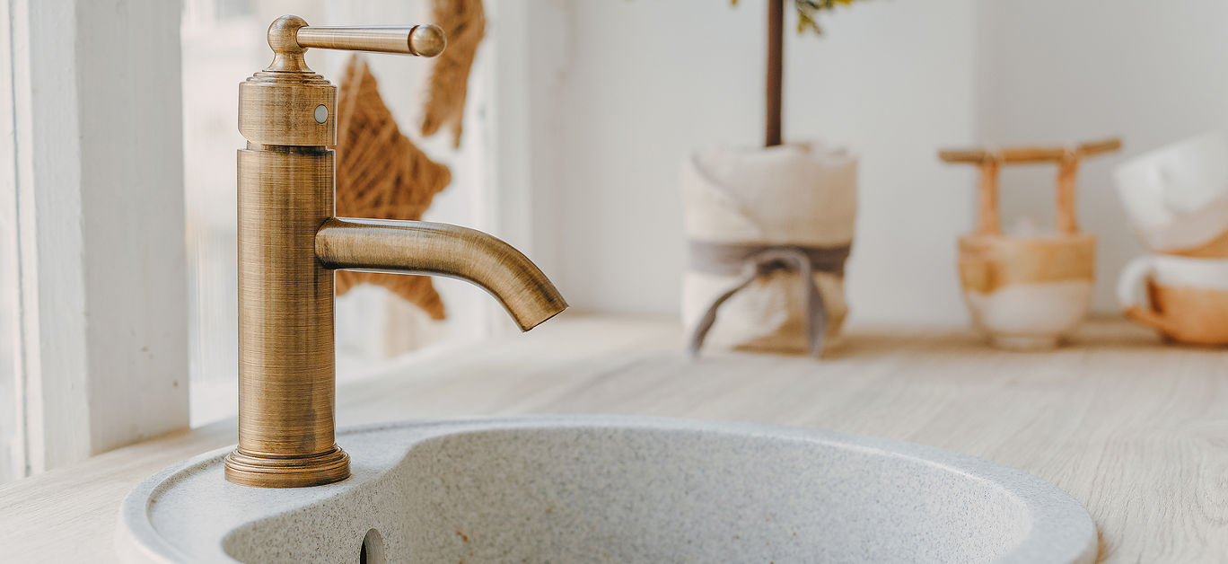 Metallic copper modern new faucet in a bright kitchen