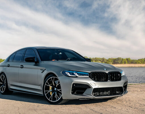 New BMW M5 F90 Competition on the background of the river.