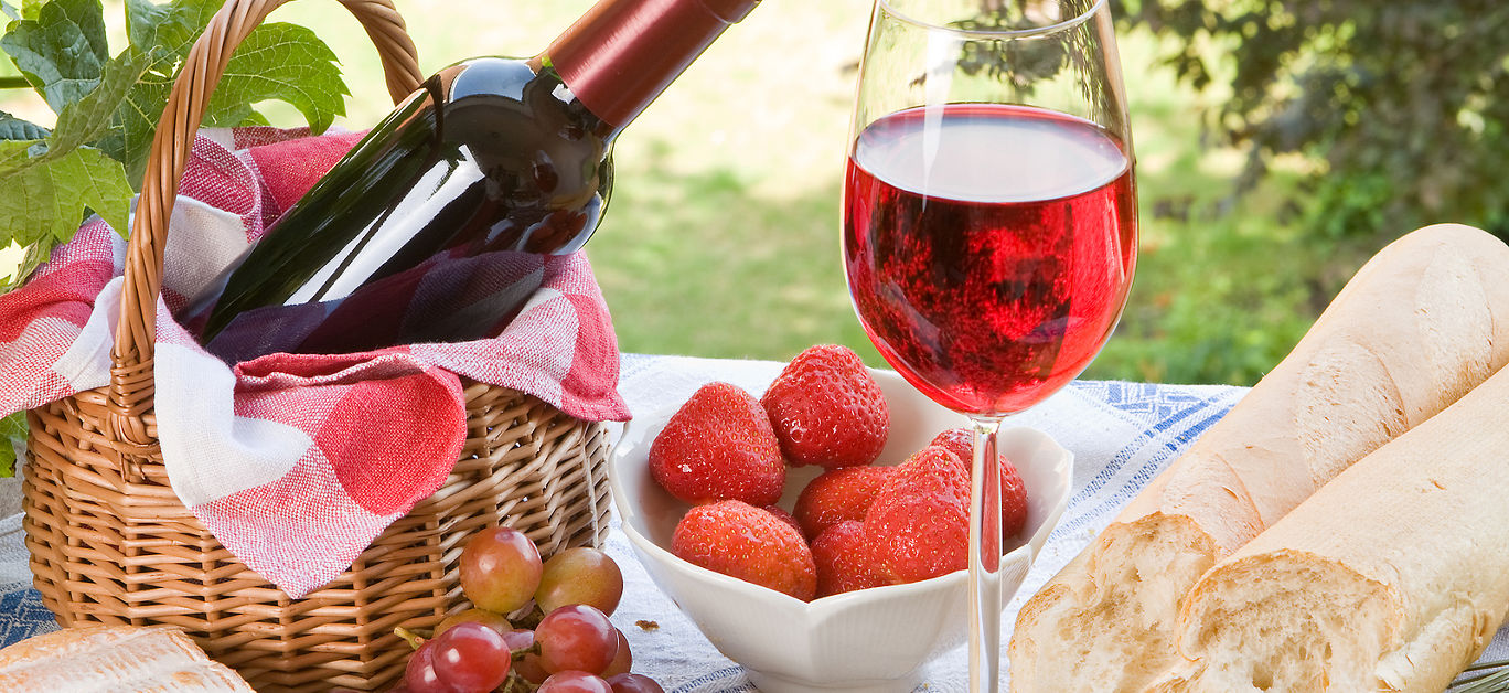 Romantic picnic setting with wine bread and cheese