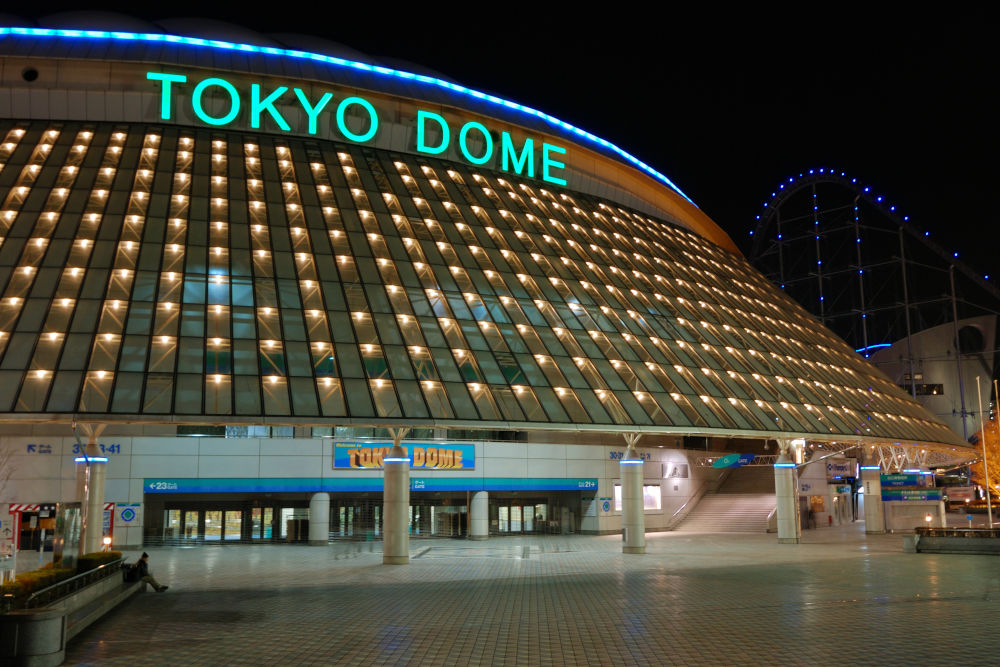 famous Tokyo Dome arena building in Korakuen district of Japanese capital with scenic evening illumination.