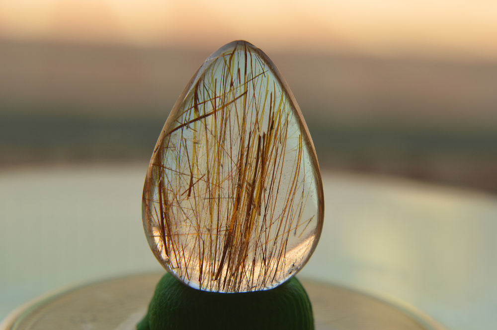 Red Rutilated quartz, cut & polished cabochon, locality, Pakistan.