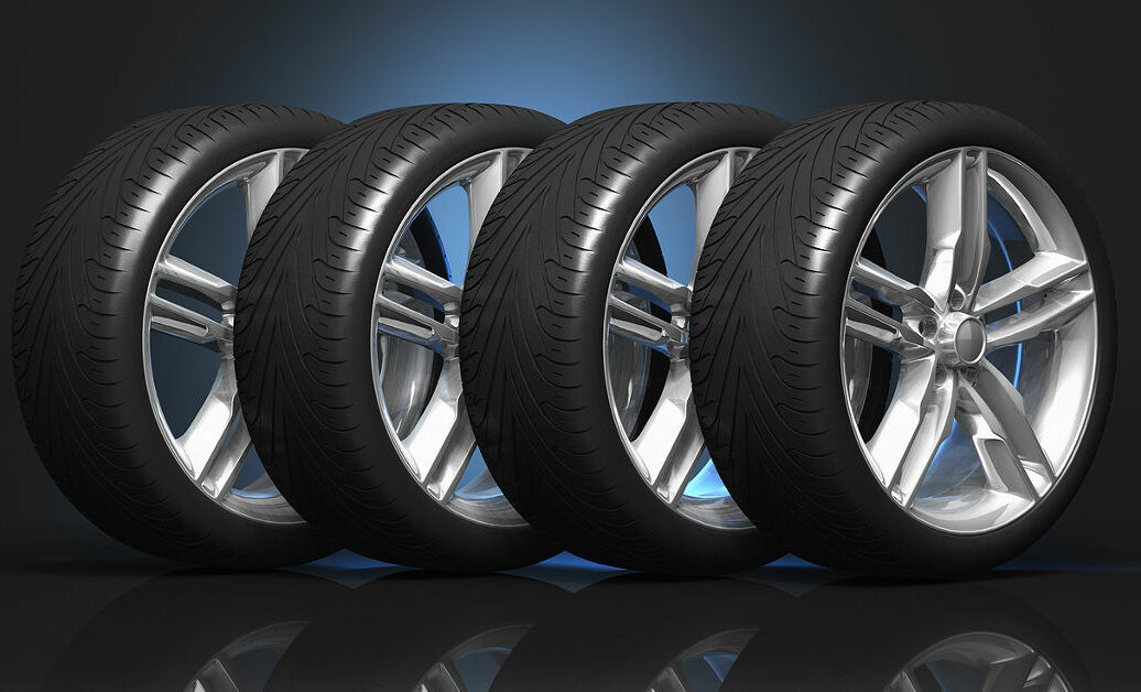 Set of four luxury car wheels on black reflective background