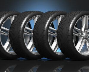 Set of four luxury car wheels on black reflective background