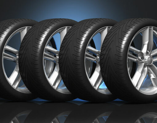 Set of four luxury car wheels on black reflective background