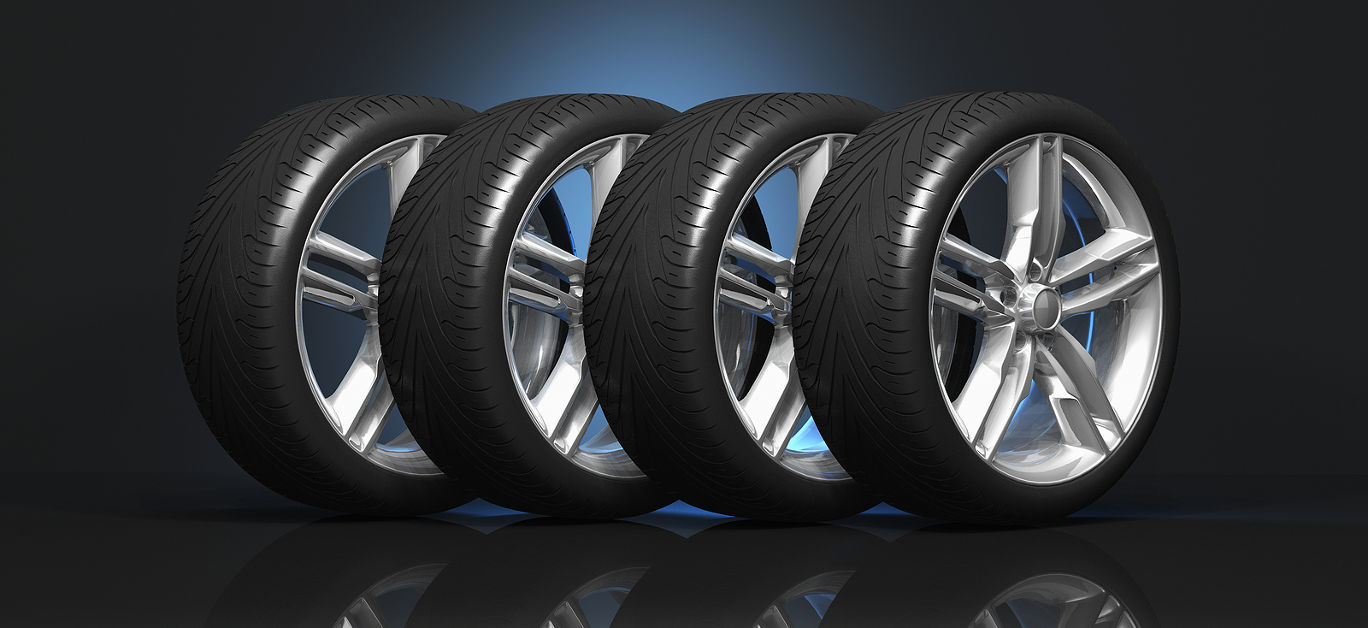 Set of four luxury car wheels on black reflective background