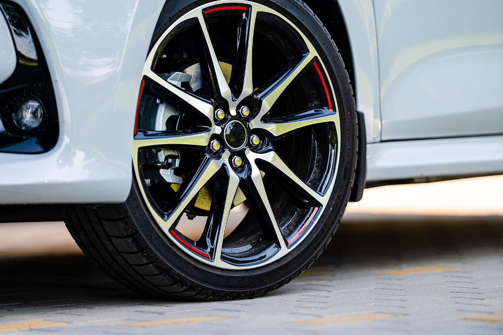 sports car wheels, low profile tires on aluminum rims, close-up, selective focus