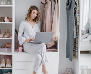 Young woman chooses things online from the comfort of your dressing room. Online shopping