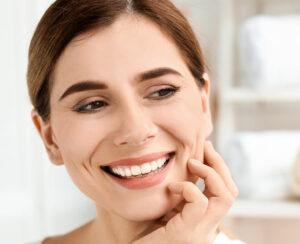 Young woman with beautiful smile indoors. Teeth whitening