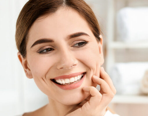 Young woman with beautiful smile indoors. Teeth whitening