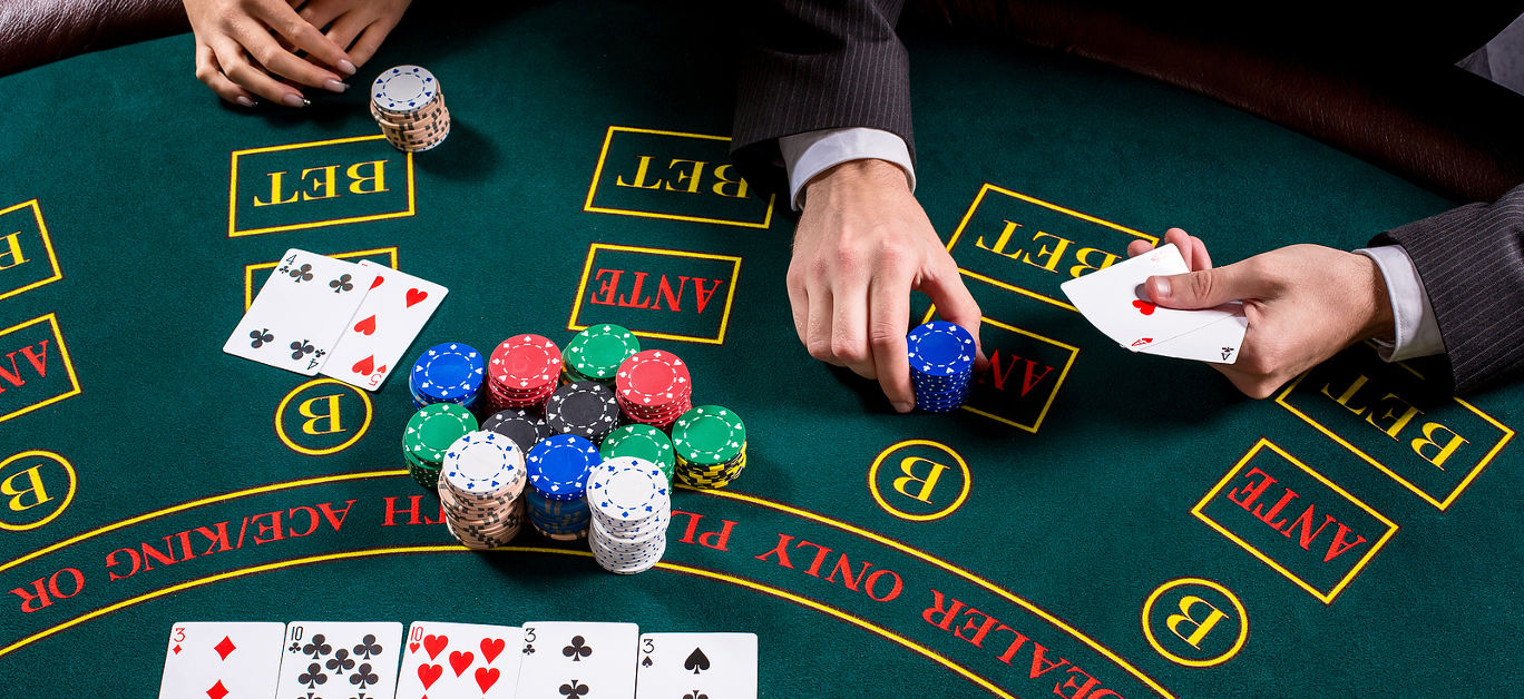 couple playing poker at the table.