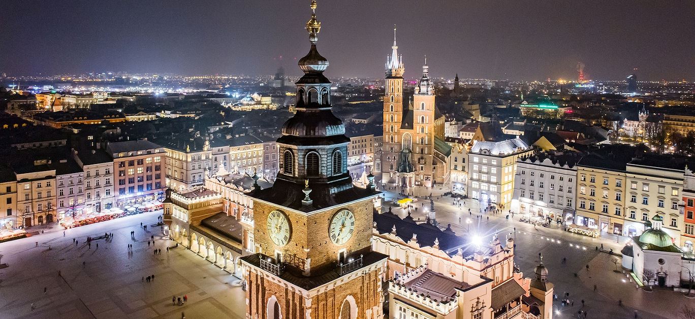 Aerial drone view Cracow old town and city main square at night. Cracow, Lesser Poland