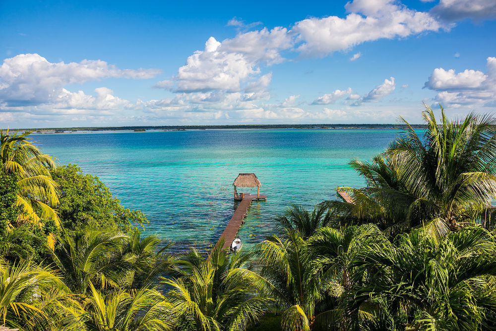 Perfect view of caribbean lagoon Bacalar. Seven Color water. Pier and Hut.