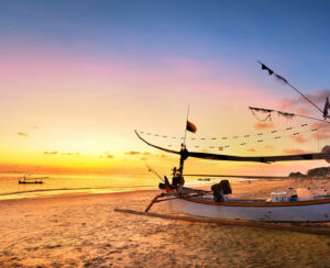 Drifting boat on the beach at sunset time . Bali Indonesia