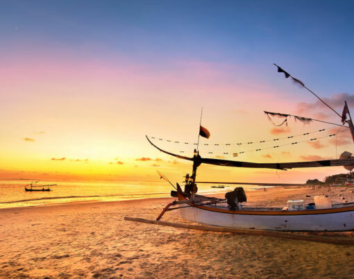 Drifting boat on the beach at sunset time . Bali Indonesia