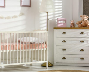 Cozy baby room interior with comfortable crib