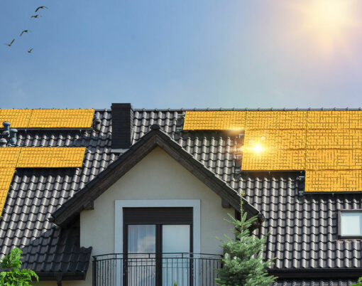 Golden solar panels on roof of beautiful modern house. Concept of saving money