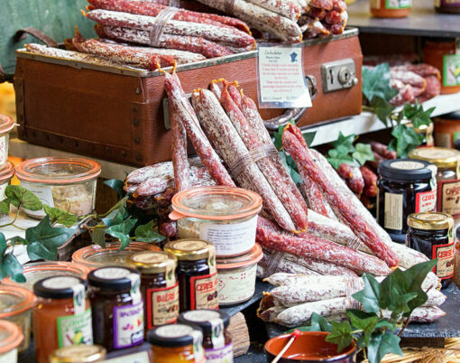 Great selection of___ salami and jam. Photo taken in a street market Borough Market in London.