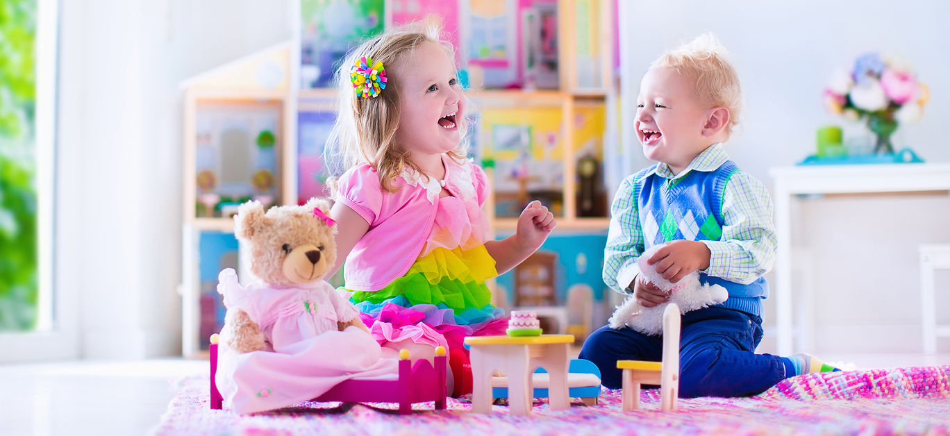 Kids playing with doll house and stuffed animal toys